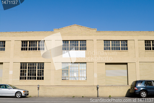 Image of Exterior of Old Warehouse, Street, Parked Cars, Blue Sky