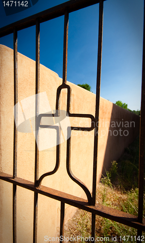 Image of Cross Shape Iron Gate Adobe Wall Blue Sky Vignette