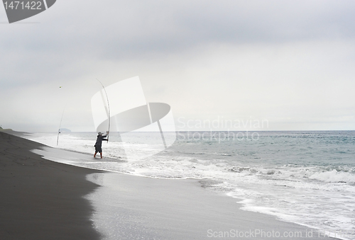 Image of Fisherman on the ocean beach