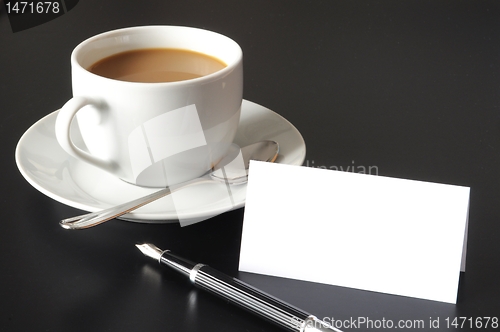Image of cup of coffee and paper copyspace