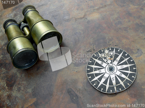 Image of Old binoculars and compass rose