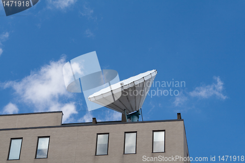 Image of Large Satellite Dish on Roof, Blue Sky Background