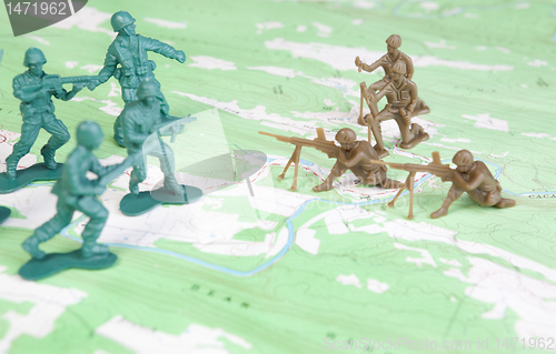 Image of Plastic Army Men Fighting on Topographic Map Two Armies Battle