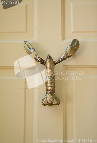 Image of Lobster Shaped Door-Knocker On Yellow Wooden Door