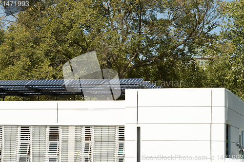 Image of Modern Solar Home with Row PV Panels on Roof 