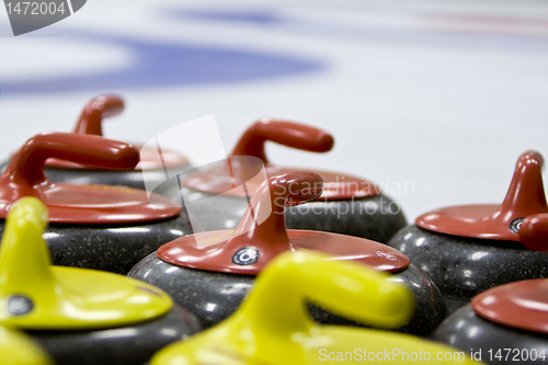 Image of Group of Granite Curling Stones In an Ice Rink        