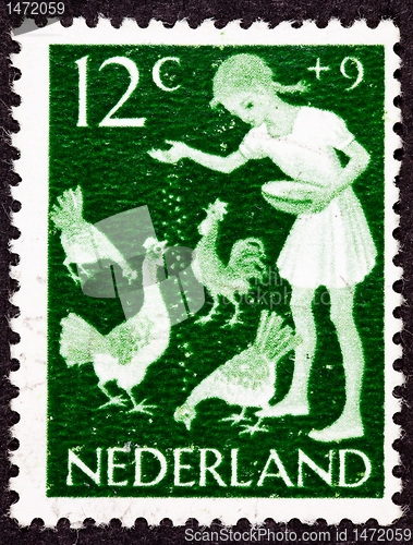 Image of Canceled Dutch Netherlands Postage Stamp Farm Girl Feeding Chick