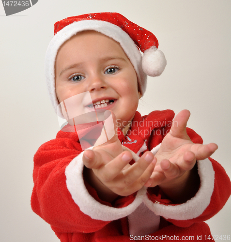 Image of cute little smiling Santa toddler girl