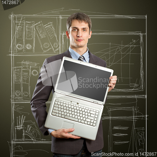 Image of businessman with open laptop in his hands