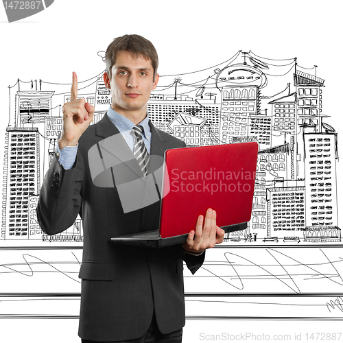 Image of male in suit with laptop with idea