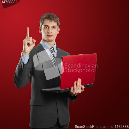 Image of male in suit with laptop with idea