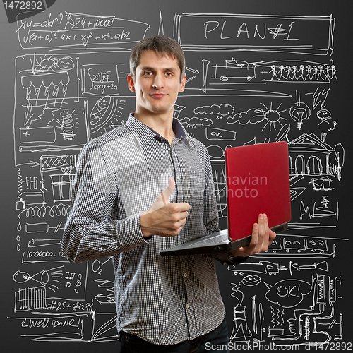 Image of male with laptop in his hands well done
