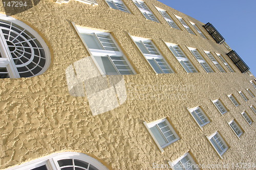 Image of Yellow stucco building angled perspective
