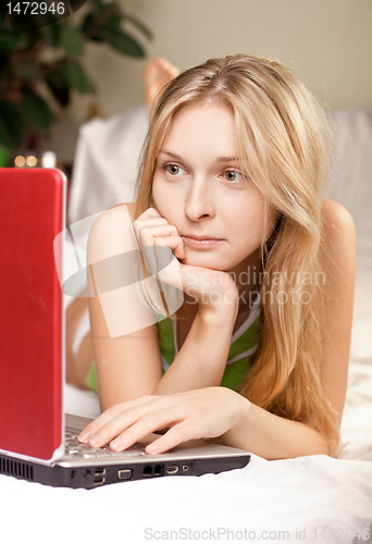 Image of woman in bed with laptop