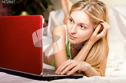 Image of woman in bed with laptop