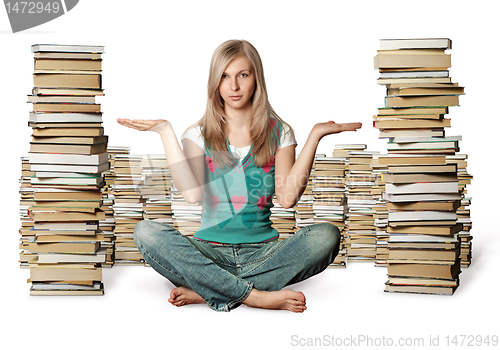 Image of woman in lotus pose with many books near