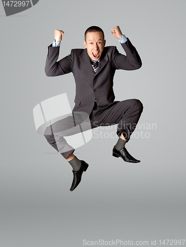 Image of Happy businessman jumping