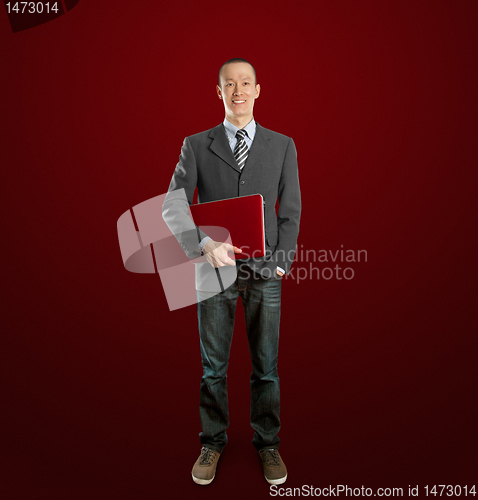Image of male in suit with laptop in his hands