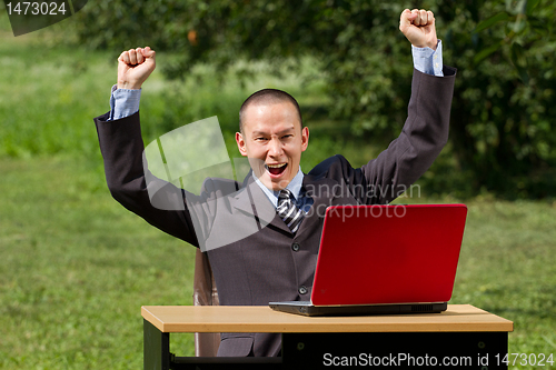 Image of man with laptop working outdoors