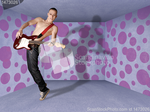 Image of punk man in cardboard room with the guitar
