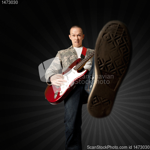 Image of rocker with guitar and foot