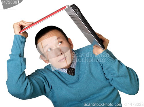 Image of young businessman hides under the laptop