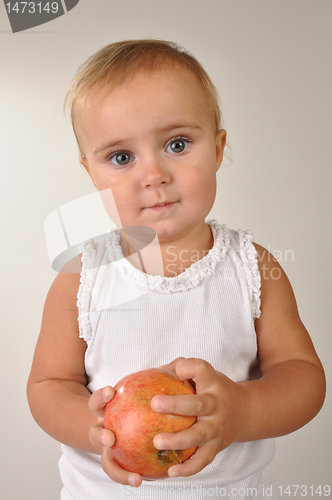 Image of baby with an apple