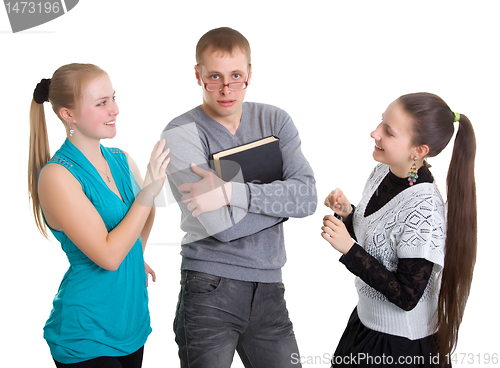 Image of Two girls and a guy with glasses with a book