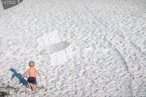 Image of Small boy walking on beach