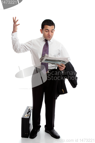 Image of Businessman with newspaper throwing up hands