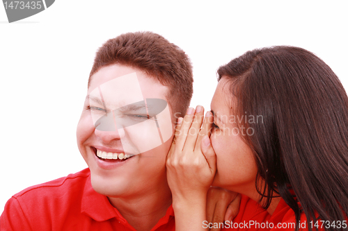 Image of woman telling a man a secret - surprise and fun faces - over a w