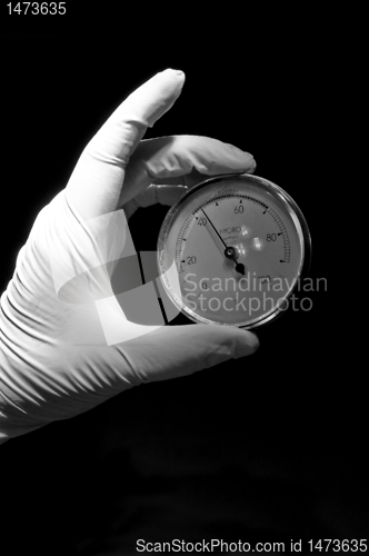 Image of Covered in white glove holding round watch