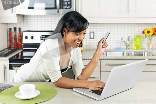 Image of Woman shopping online at home