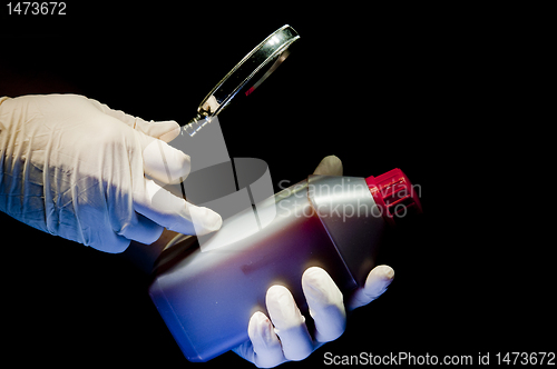 Image of Hands covered in white gloves and container