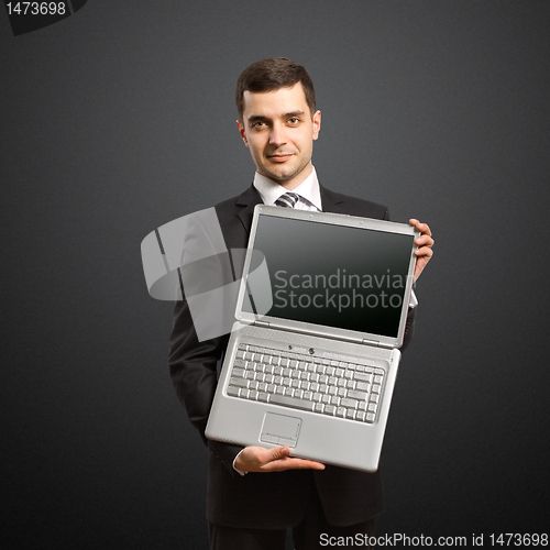 Image of businessman with open laptop in his hands