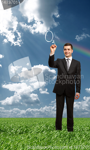 Image of businessman writting something with marker outdoors