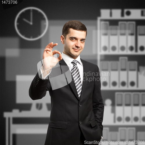 Image of happy businessman in suit shows OK
