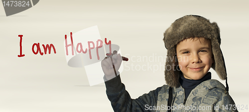 Image of Child writes with a pen I am Happy