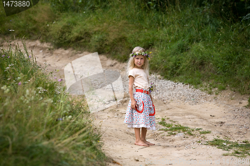 Image of little girl standing on the road