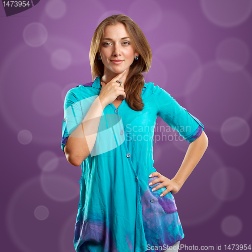 Image of woman in blue looking on camera
