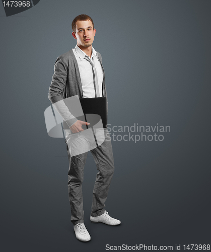 Image of male in with laptop in his hands