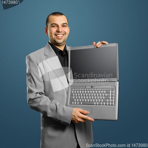 Image of businessman with open laptop in his hands
