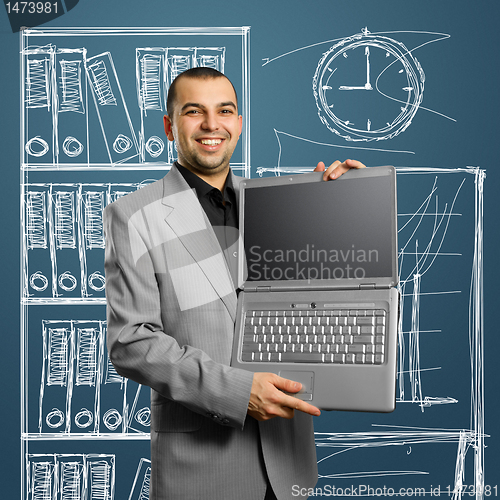 Image of businessman with open laptop in his hands