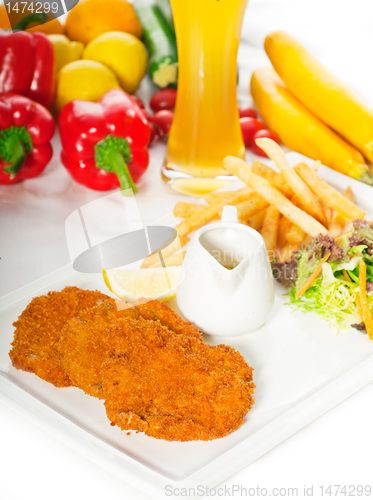 Image of classic Milanese veal cutlets and vegetables