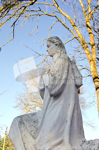 Image of Dirty old white angel statue without wings.