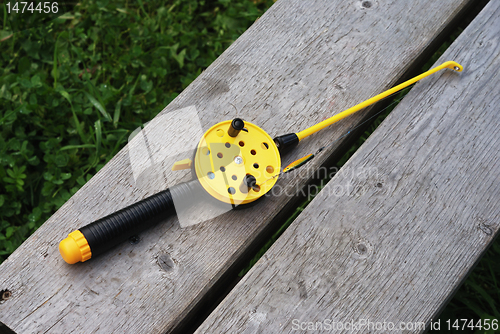 Image of fishing rod with yellow reel 