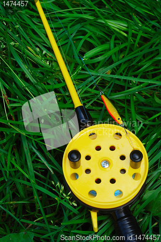 Image of fishing rod with yellow reel  