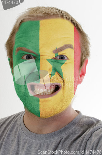 Image of Face of crazy angry man painted in colors of senegal flag