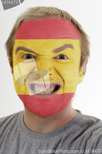 Image of Face of crazy angry man painted in colors of Spain flag