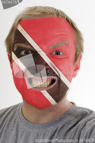 Image of Face of crazy angry man painted in colors of Trinidad and Tobago